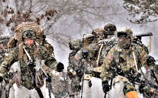 Military soldiers hiking in the snow