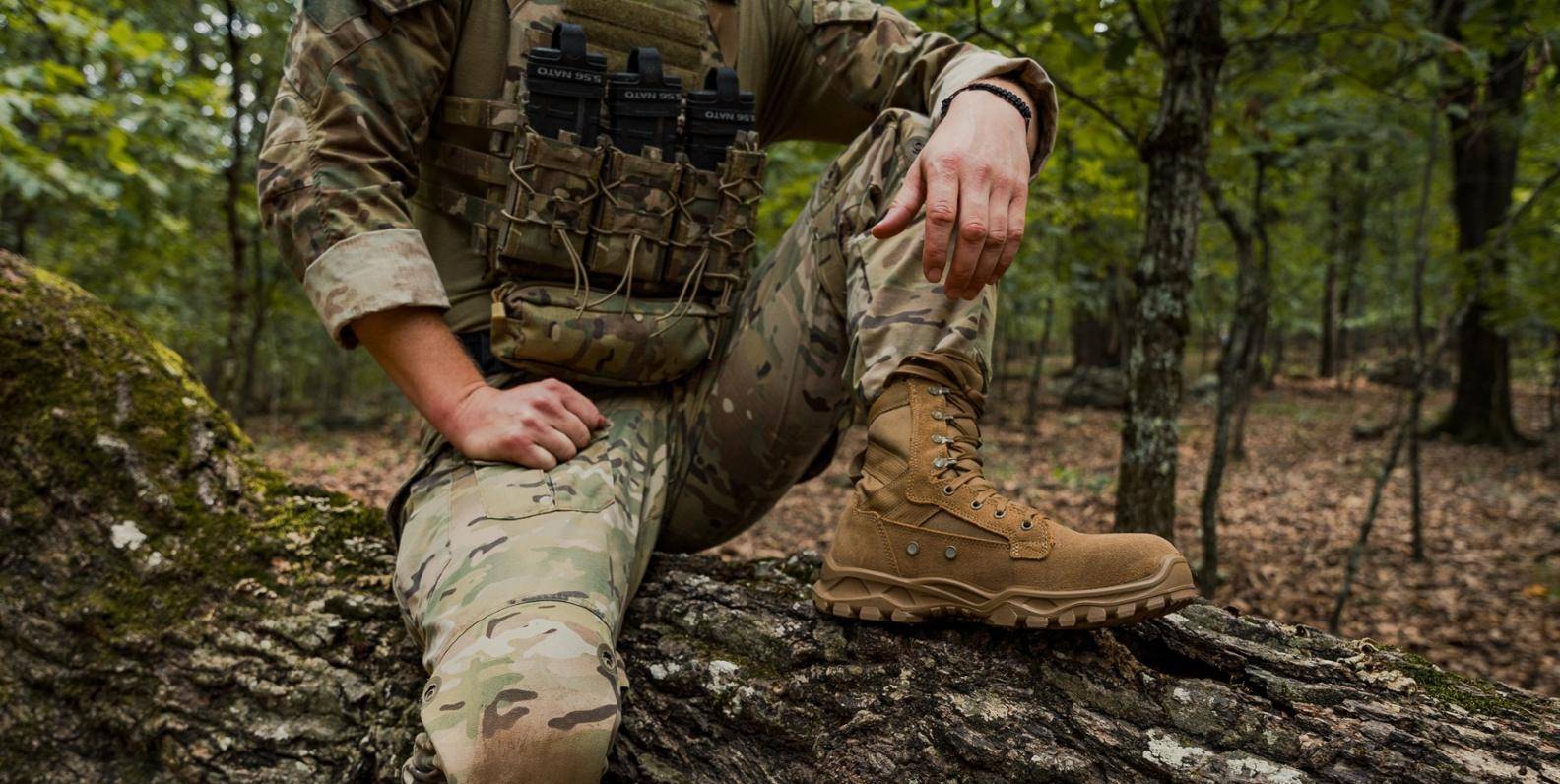 Soldier kneeling in forest wearing combat boots