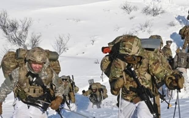 Soldiers hiking through snow