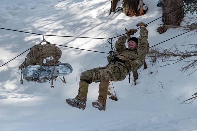 Soldiers ziplining in Snow Environment