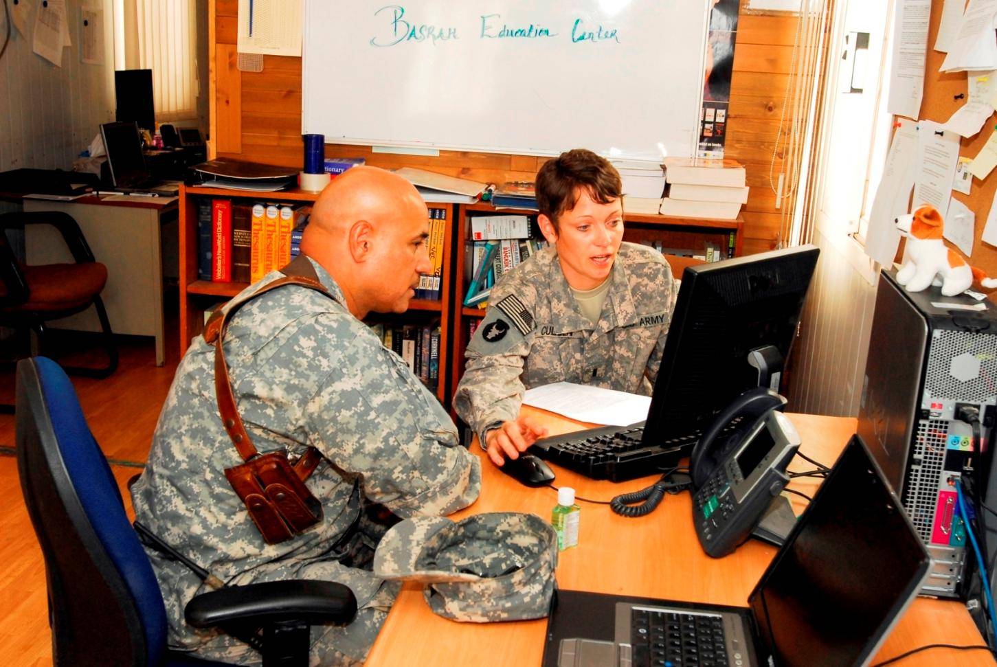 Soldiers looking at computer screen