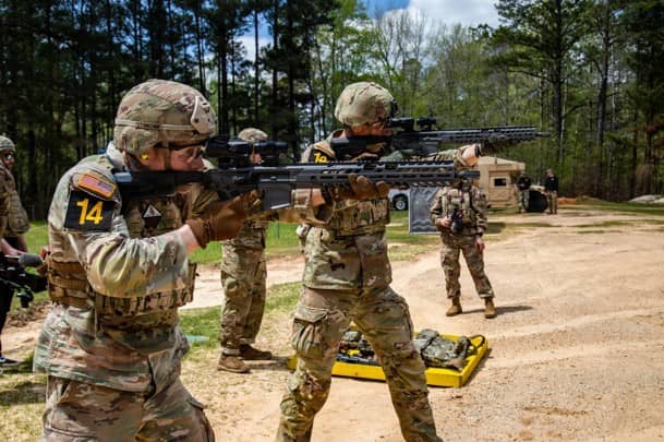 Ranger teams in uniform holding rifles in competition
