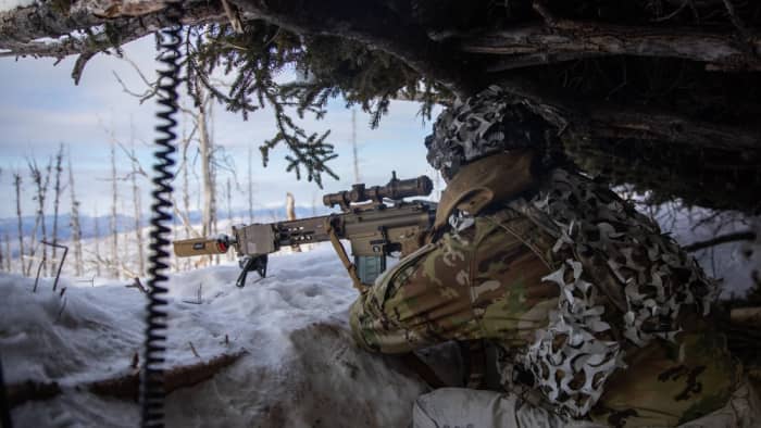 Soldier pulls security with rifle in snow