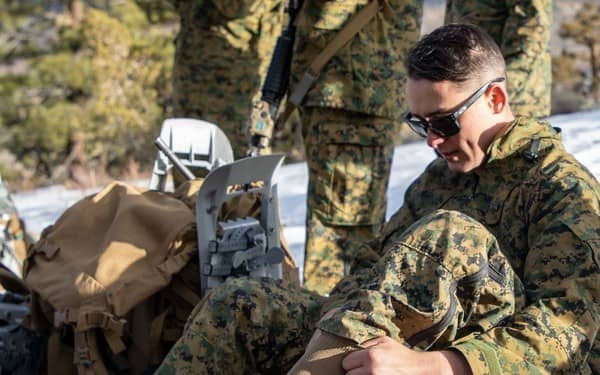 Soldier putting on socks