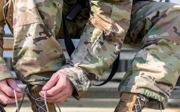 Soldiers sitting down tying boot laces